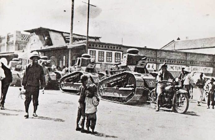 parade of tanks as people look on